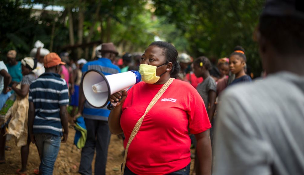 Lucina, in the largest market place in the region of Jacmel - Cap Rouge, promoting safe hygiene practices during the Covid-19 sanitary health alert.