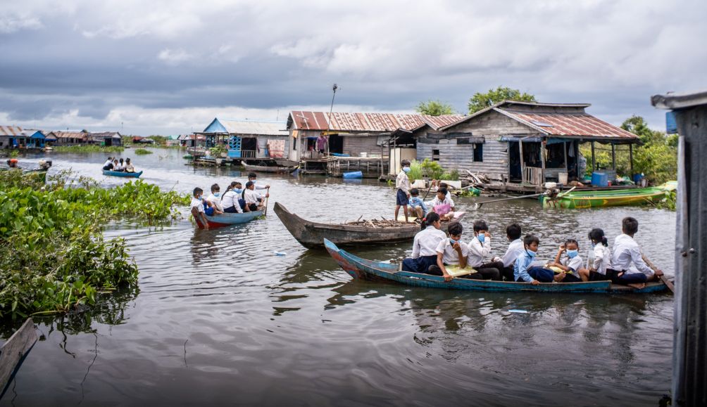 Children in Pursat, Cambodia travel to school on boats during the wet season.