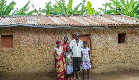 a family posing for a photo in front of their house