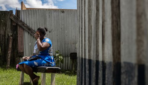 Woman on a bench covering her face