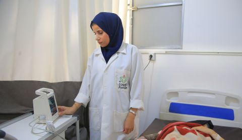 A nurse in uniform standing in a hospital