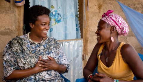 Celebrity Wunmi speaking to a woman and smiling.
