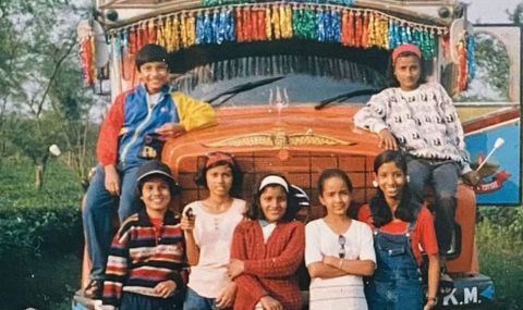 Children posing around a truck