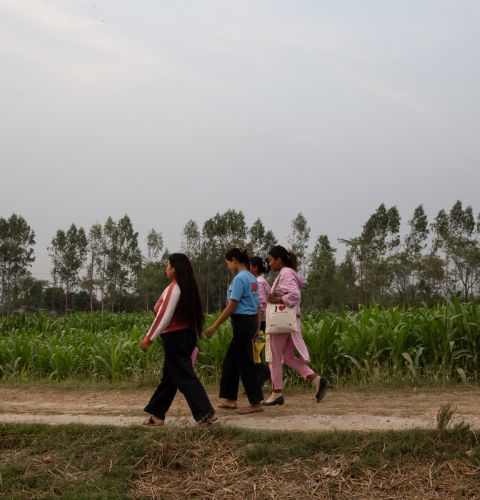 Women in Nepal, walking in a field