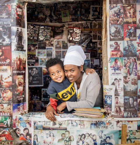 A woman and her son looking out of a shop window