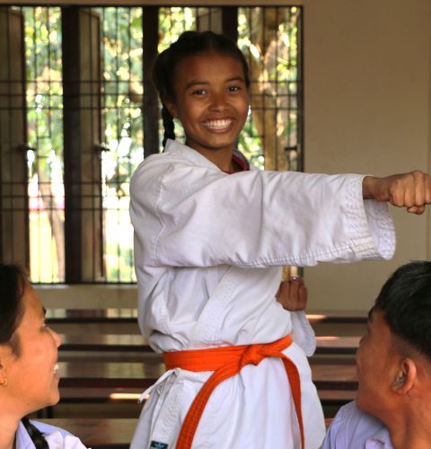 Girl in karate uniform at school