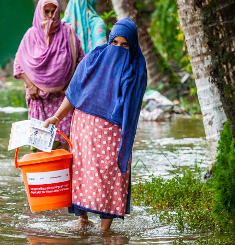 Women carrying supplies during the floods in Bangladesh
