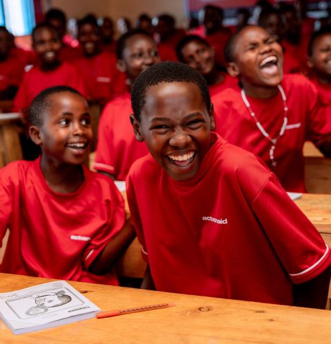 Girls laughing in a classroom at a school in Rwanda