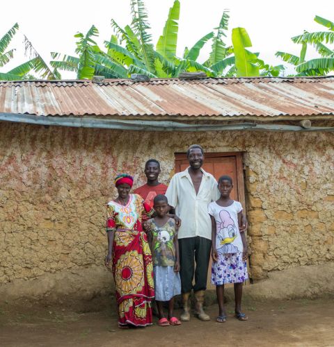 a family posing for a photo in front of their house