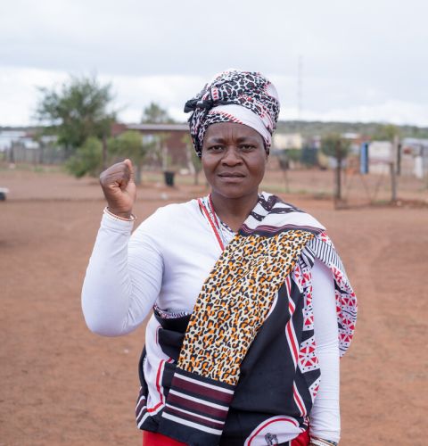 A woman holding up a fist in the air