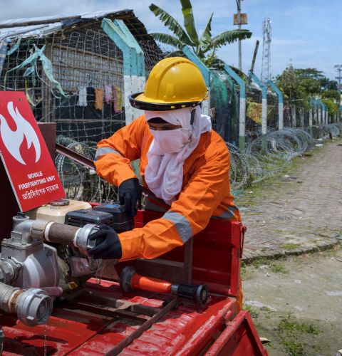 Woman in fire uniform preparing for crises