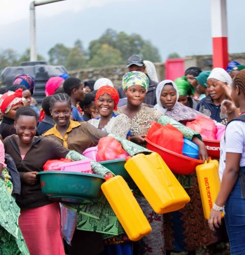 women collecting hygiene kits from other women leaders 