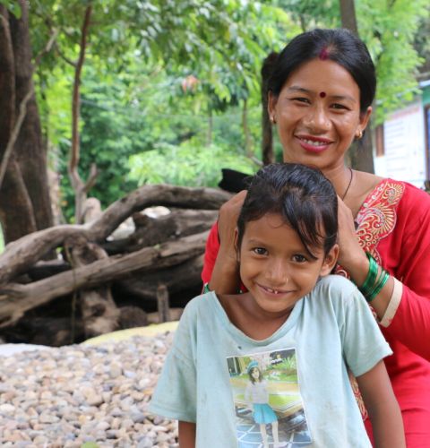 Woman and her child smiling at camera