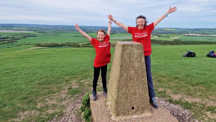 Woman and child celebrating with hands in the air
