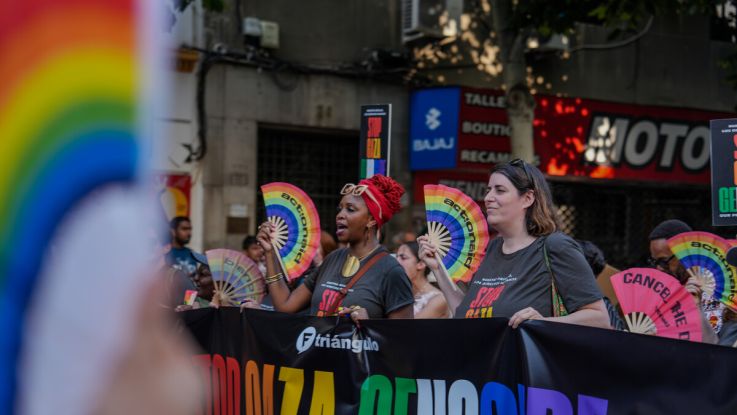 People at a march or parade, carrying a banner
