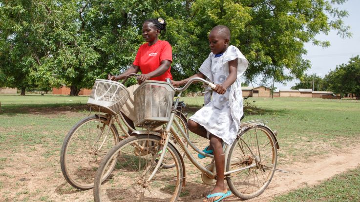Woman and a girl riding bikes