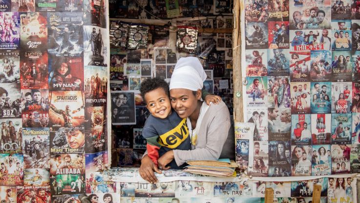 A woman and her son looking out of a shop window