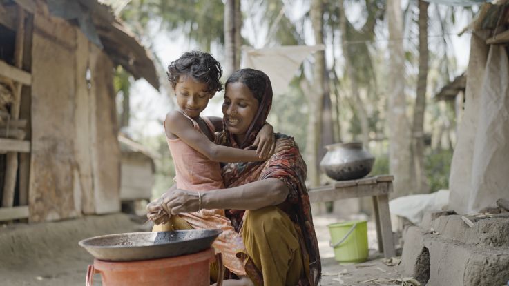 Woman with her child cooking a meal