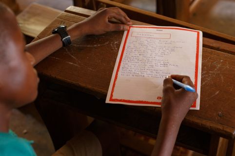 Sabastian, 14 writing a letter at school.