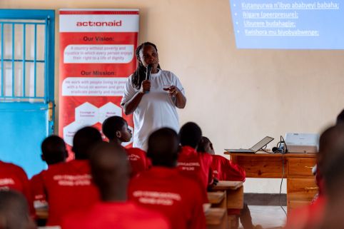 A woman giving a talk to classroom of girls